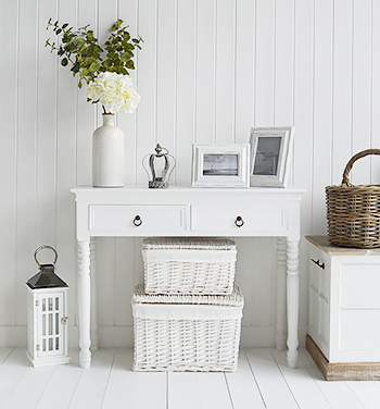 Set of white baskets under the New England Console table for extra storage