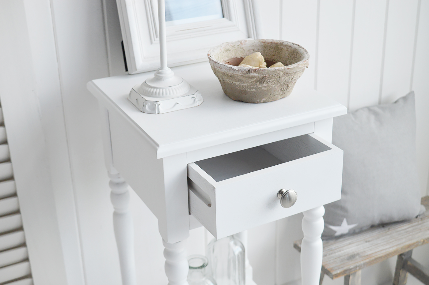 The White Lighthouse bedroom furniture. A narrow white bedside table with drawer and silver handle, can be used as a white lamp table from The Georgetown range