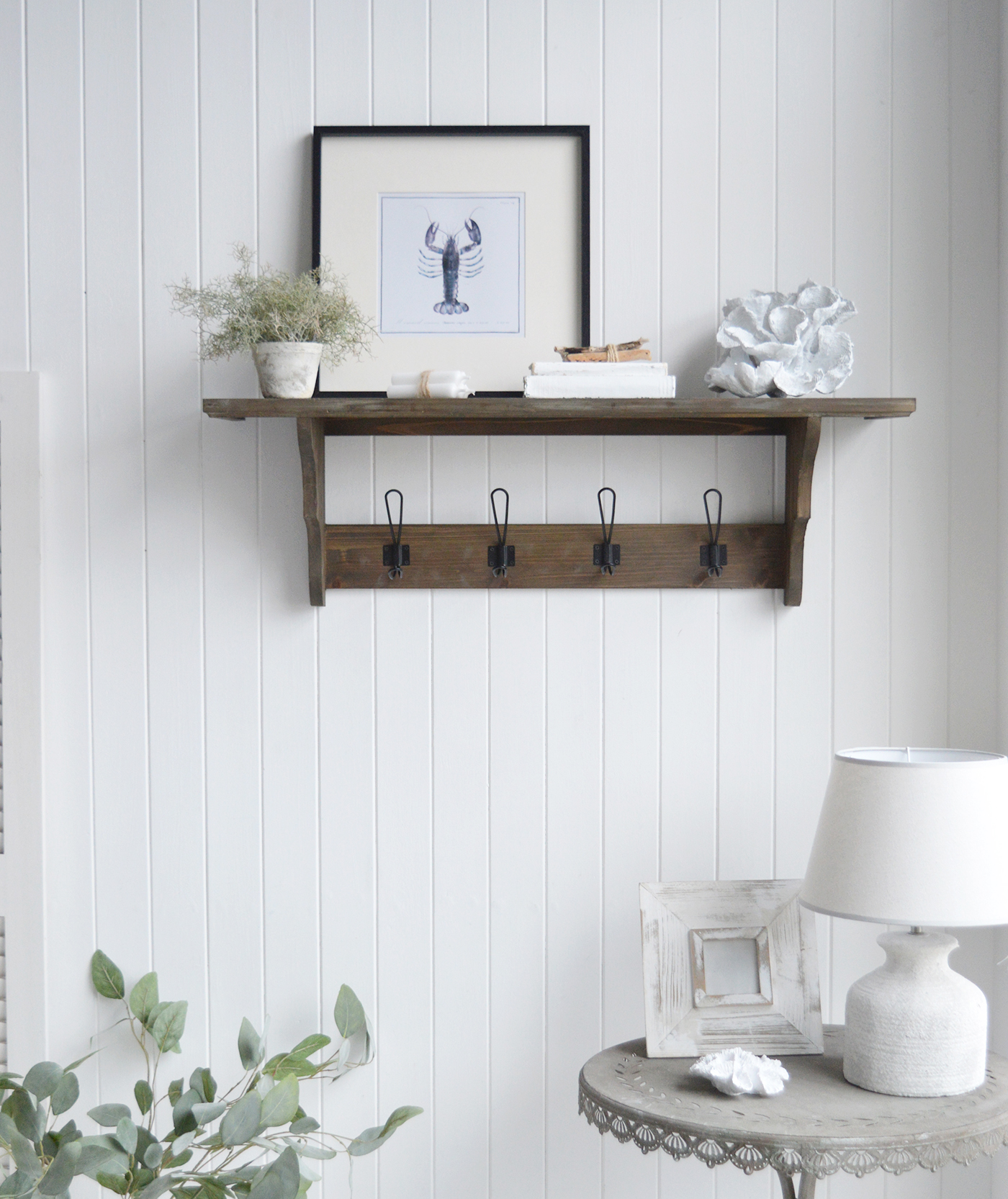 Handcrafted from solid wood, this wall-mounted  Hampden coat rack provides sturdy hooks for coats, hats, and bags, while the large shelf offers extra storage or display space.