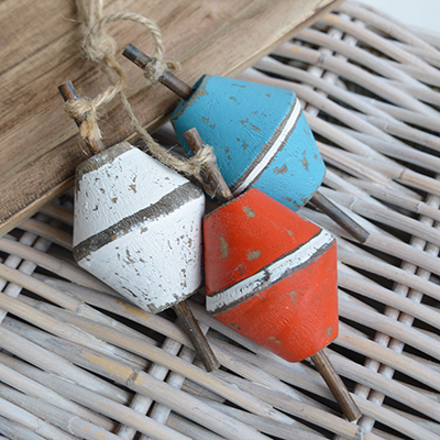 Handcrafted wooden floats styled with natural textures for beachhouse interiors