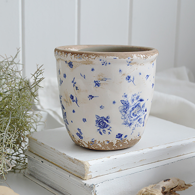 Coastal farmhouse crocks and vases in a faded blue rose pattern with a timeworn finish, bringing nautical elegance and vintage style to any space.
