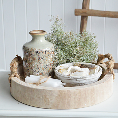 The Chadwick chunky round wooden tray is crafted from solid wood and features thick rope handles for a perfect blend of rustic charm and functionality.