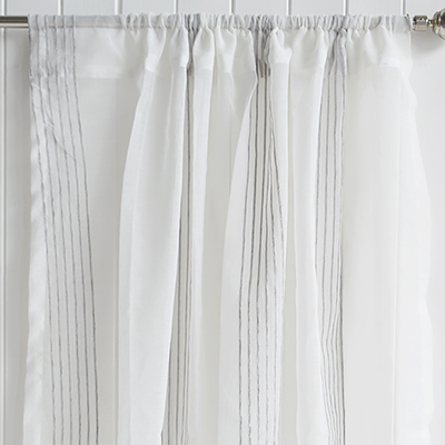 The Pebble Stripe Curtain adds effortless elegance to coastal interiors with its soft sheer voile and subtle woven stripes. Create a light and airy home with these beautifully textured coastal curtains inspired by relaxed beach house living.