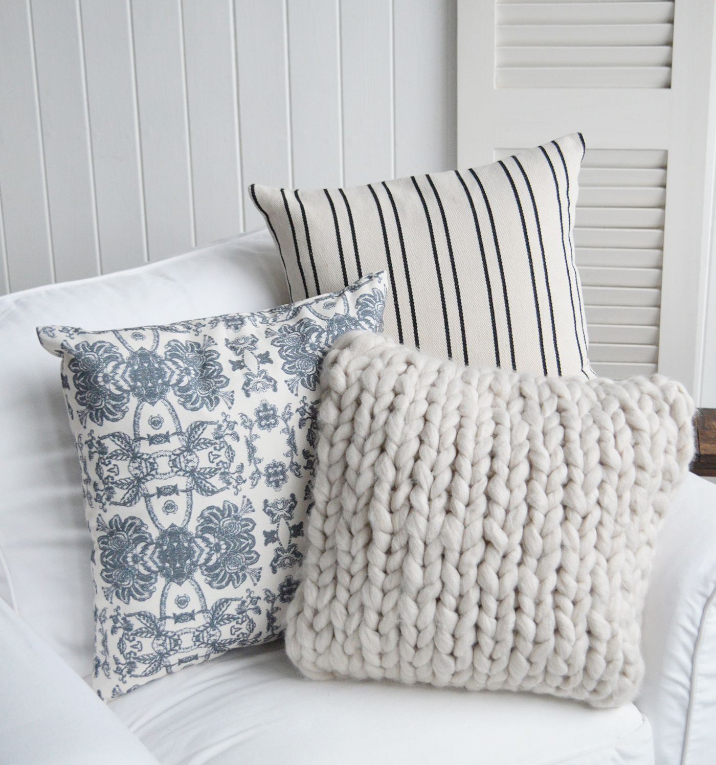 Quincy Cushion Cover in dark navy stripe and an array of cushions in blue and natural - New England Coastal and Farmhouse Homes and Interiors