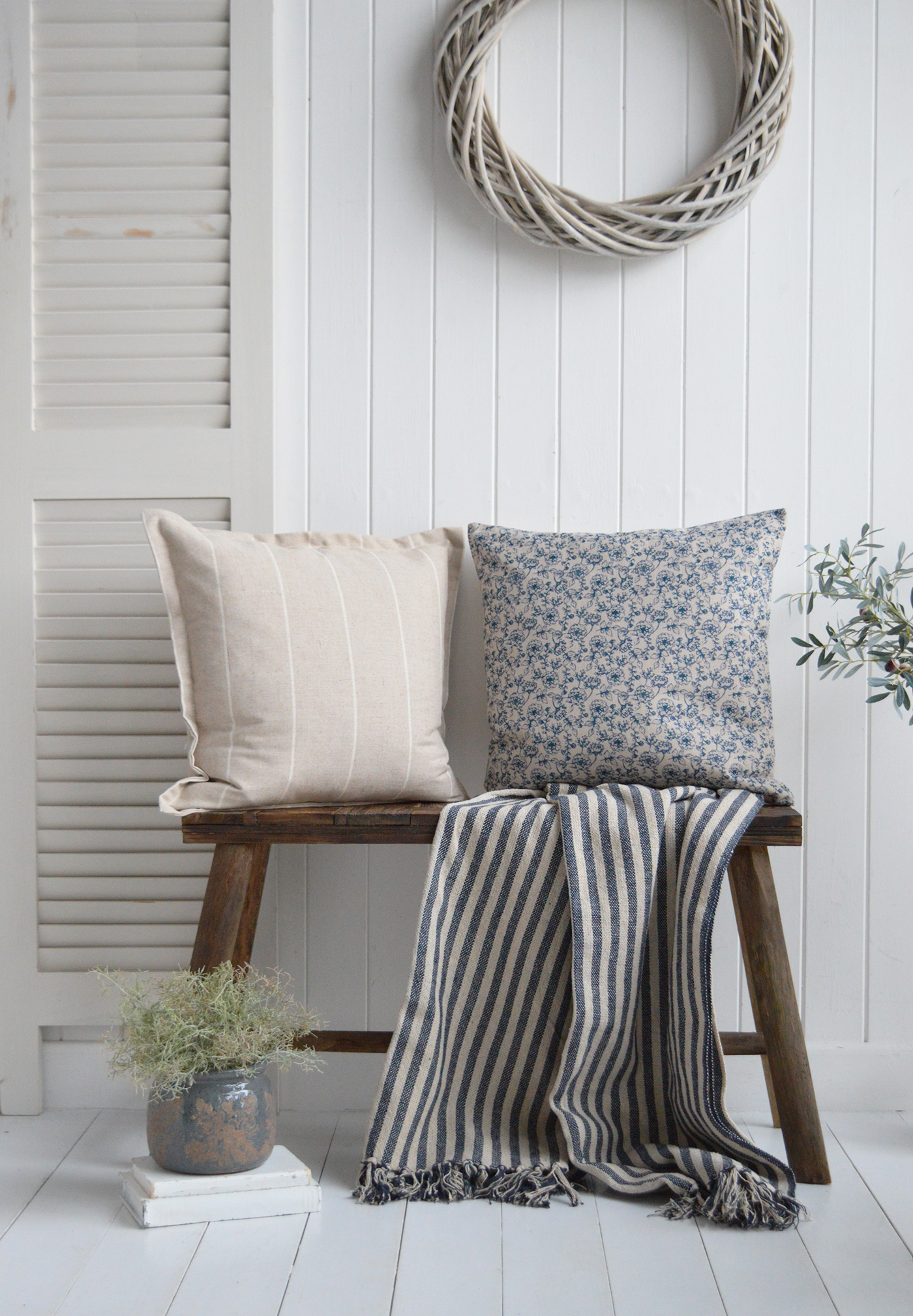 New England inspired cushion covers on the wooden bench to furnish a Hamptons or coastal inspired home interior