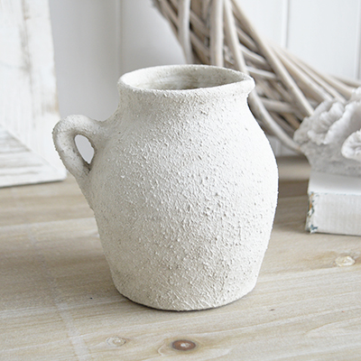 The Fremont aged white stone vases feature a weathered, textured finish that exudes rustic charm for all coastal and farmhouse settings