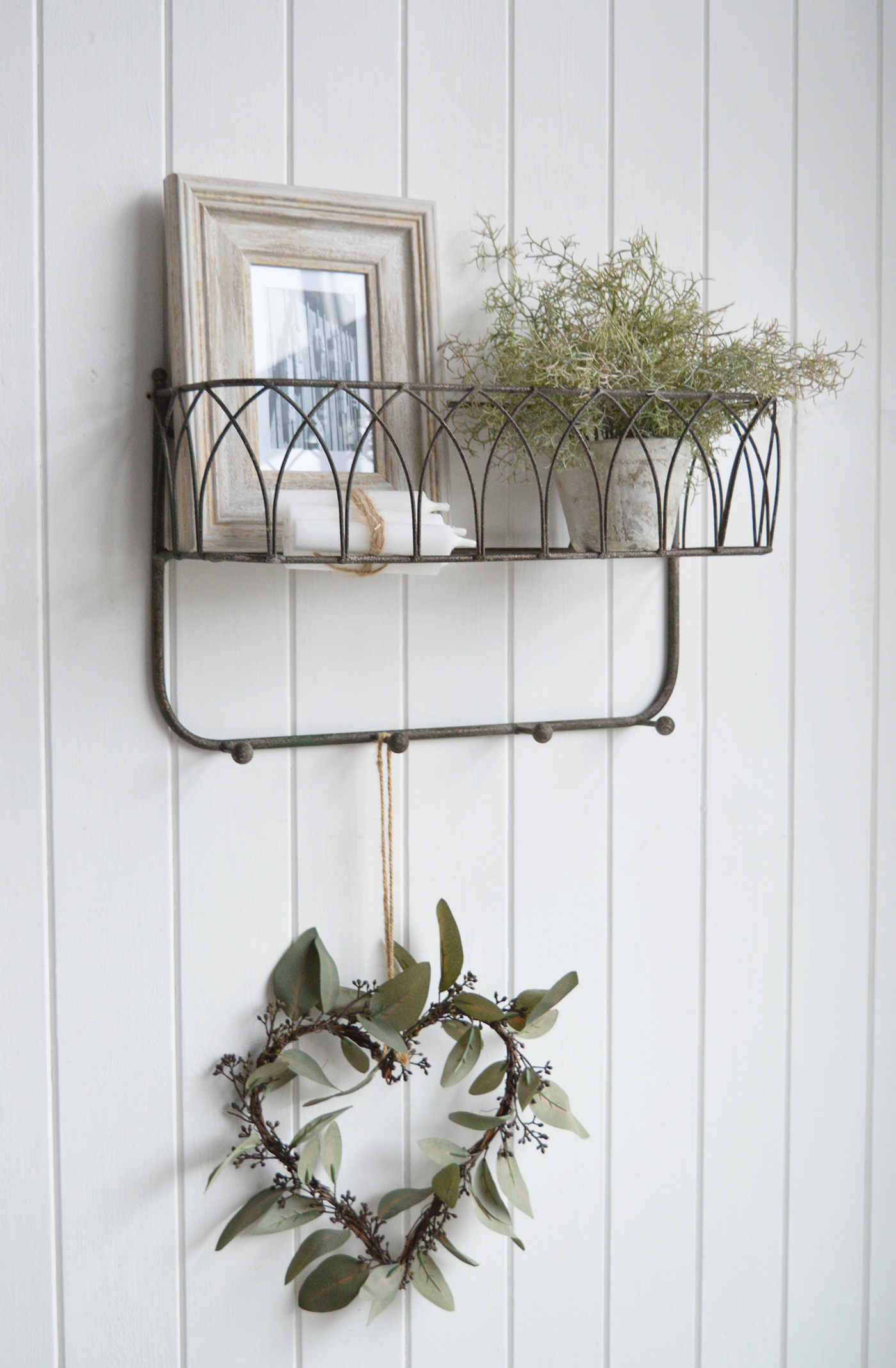 Crafted from sturdy metal with a beautifully aged patina, this versatile shelf adds character while offering a stylish display and hanging solution