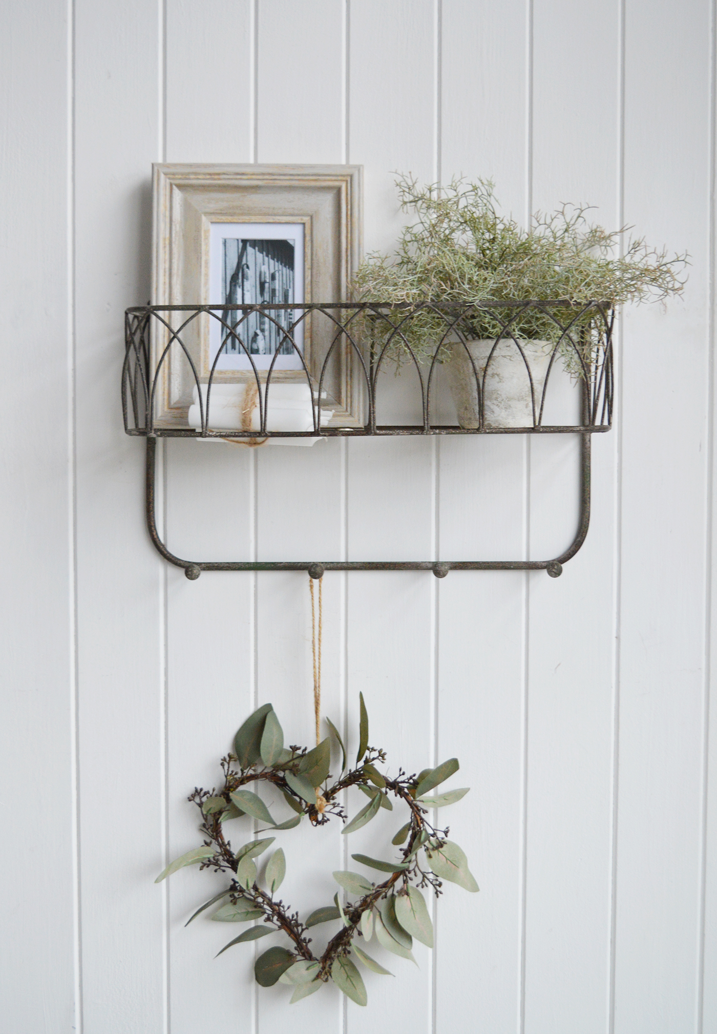 With its vintage-inspired design and distressed finish, this Chesterville wall shelf with hooks enhances interiors with a warm, lived-in feel