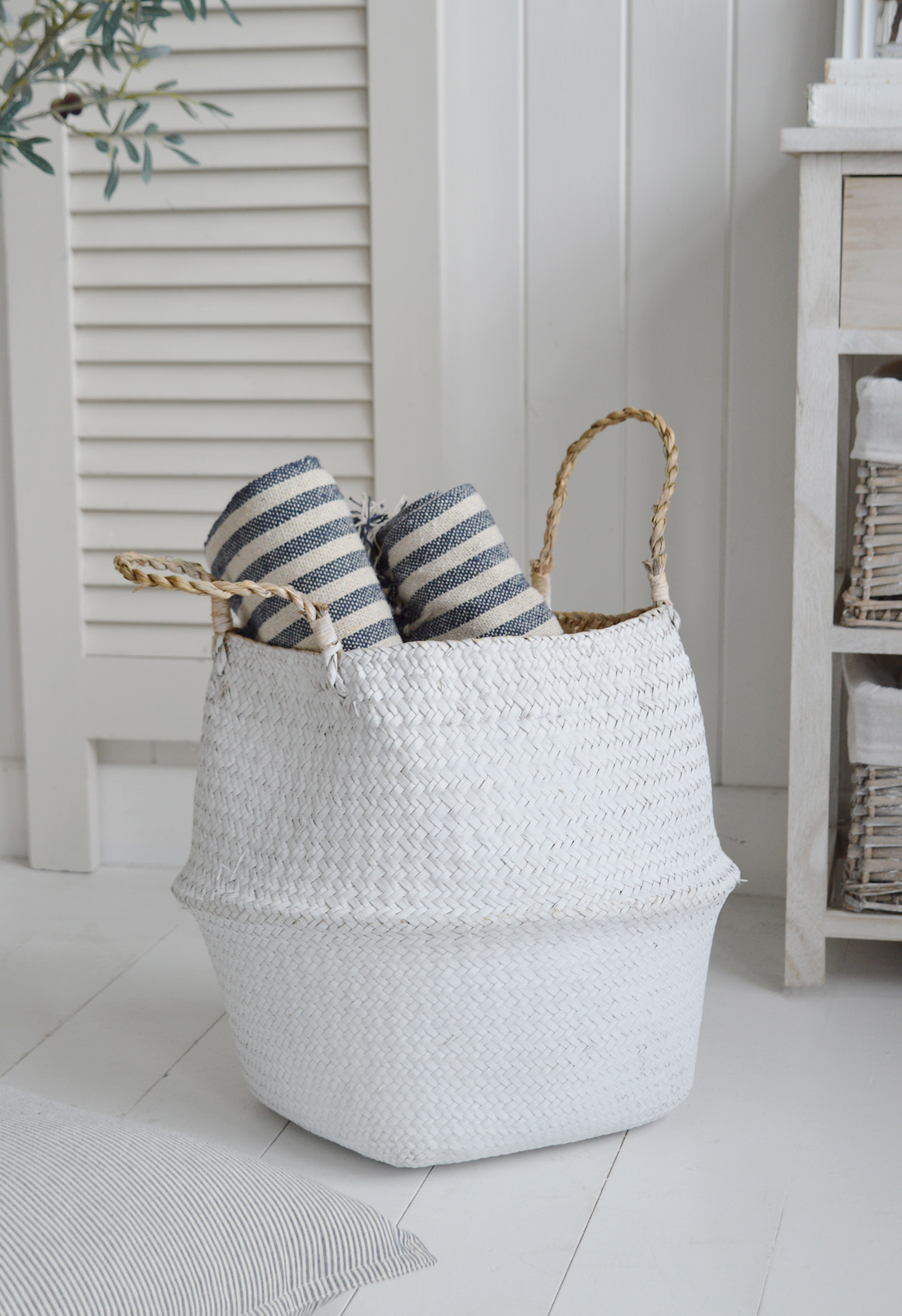 The coastal Kingston white basket filled with the Mapleton white and navy stripe throws