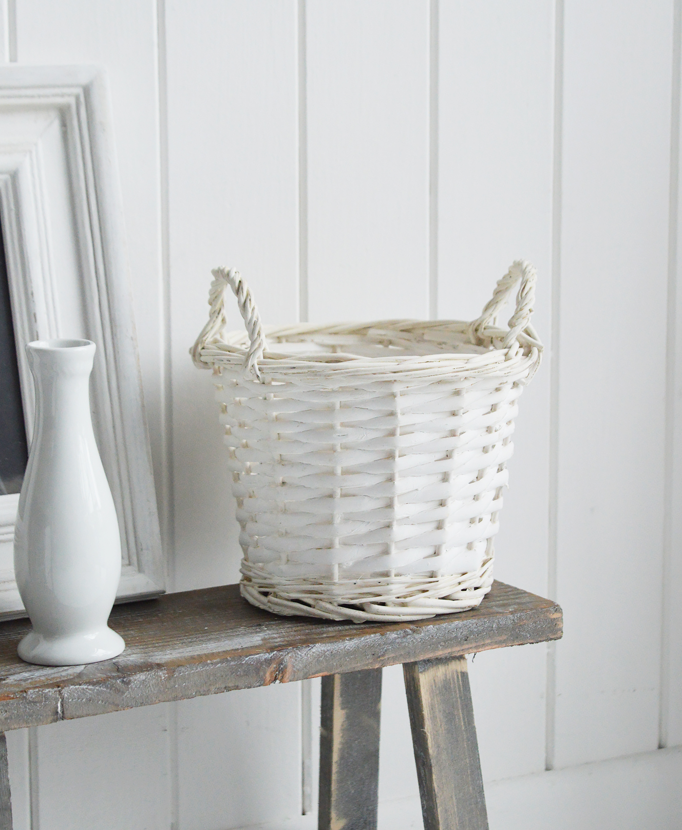 White Furniture and accessories for the home. Small white willow basket with handles. Log and storage for New England style homes in country, coastal and city 