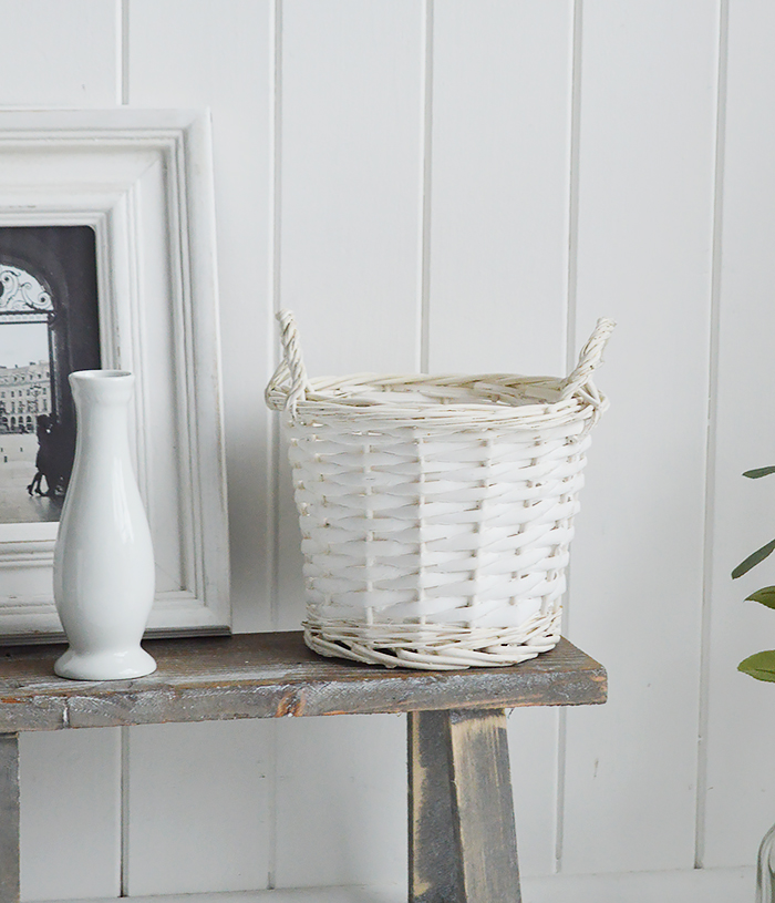 White Furniture and accessories for the home. Small white willow basket with handles. Log and storage for New England style homes in country, coastal and city 