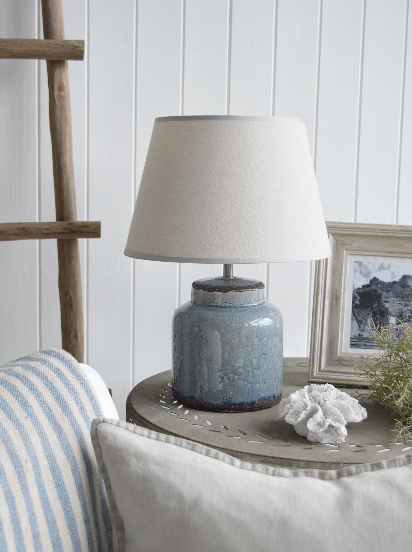 The blue Compton lamp adds a refined yet relaxed touch to a coastal-inspired interior, with its soft hue and classic design evoking the tranquility of the sea.