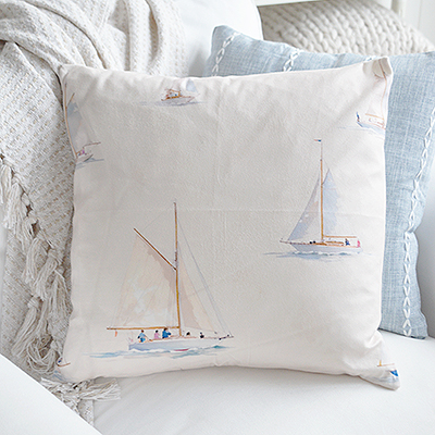 Sailboat cushion cover in pale colours, perfect for any coastal home.