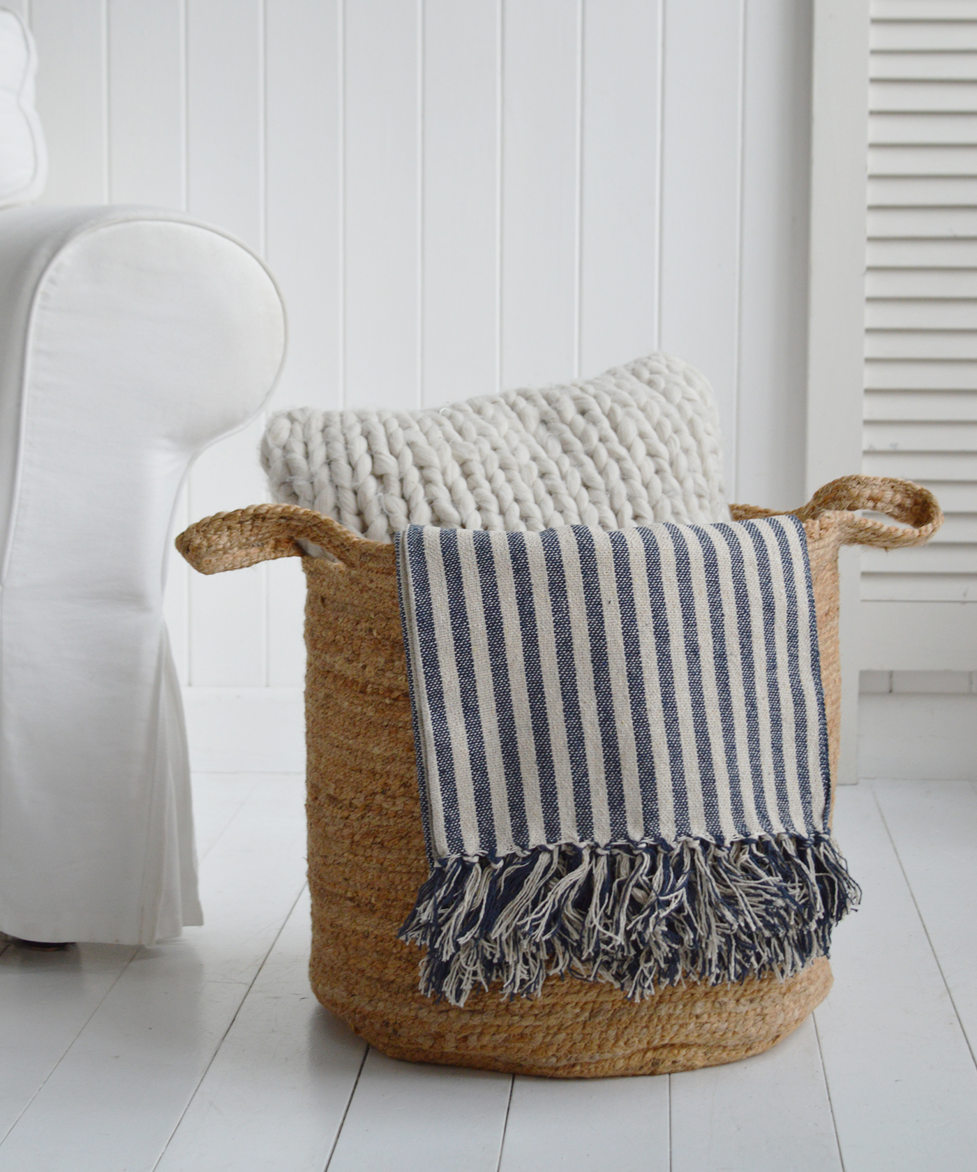 The Fall River basket, a perfect height basket beside a chair, styled with Mapleton throw and  Mayfair cushion for coastal homes and interiors