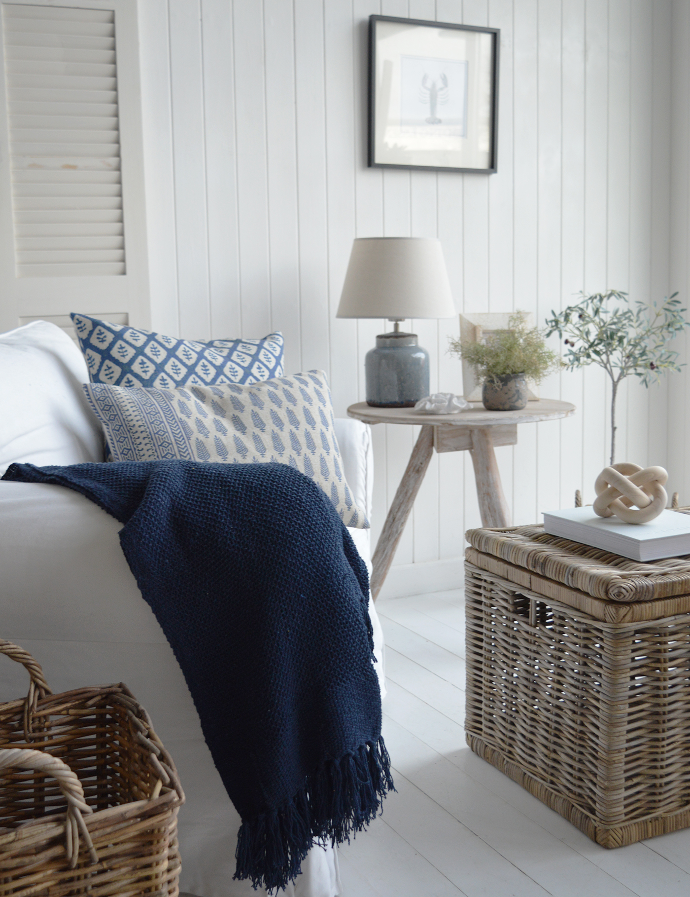 A Hamptons style living room in white and blue for seaside coastal living and interiors