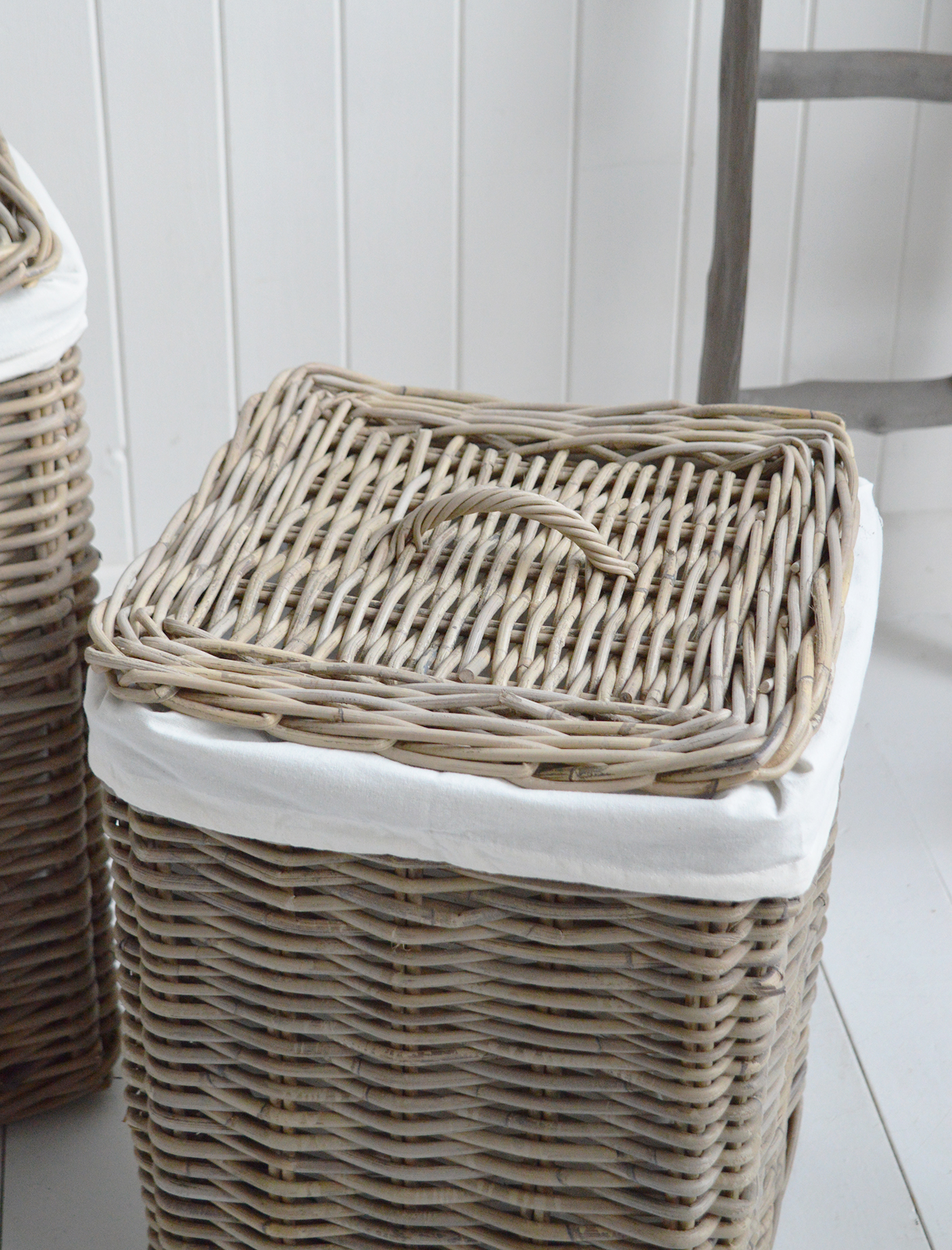 Casco Bay grey rattan laundry baskets with a lid in 2 sizes and removeable linings for in a New England style coastal or farmhouse bathroom or bedroom