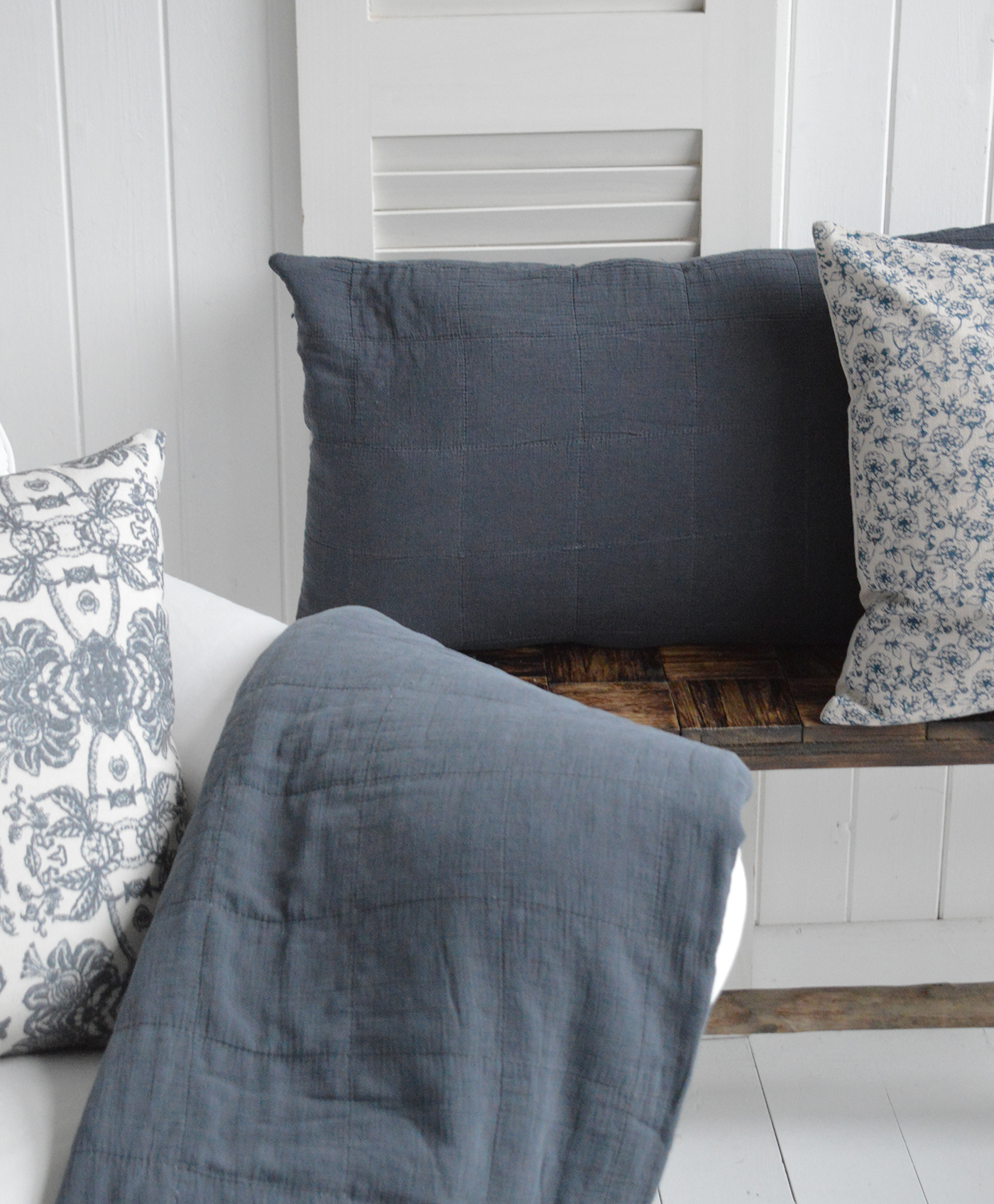 Piermont blue cushion cover with an array of navy cushions