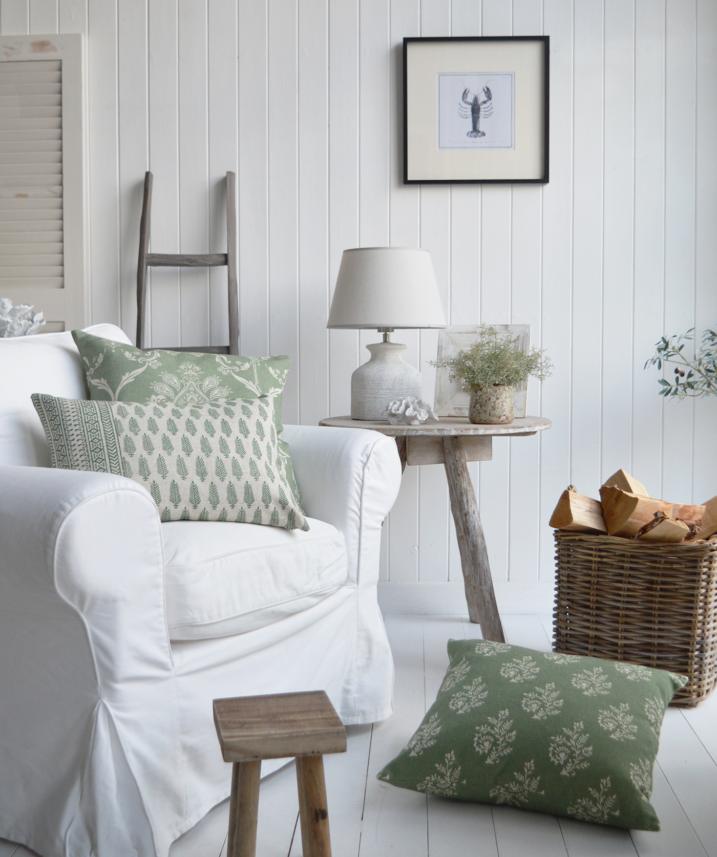 The Serenity cushions in a cosy Hamptons inspired living room with a driftwood table , casco bay basket filled with logs