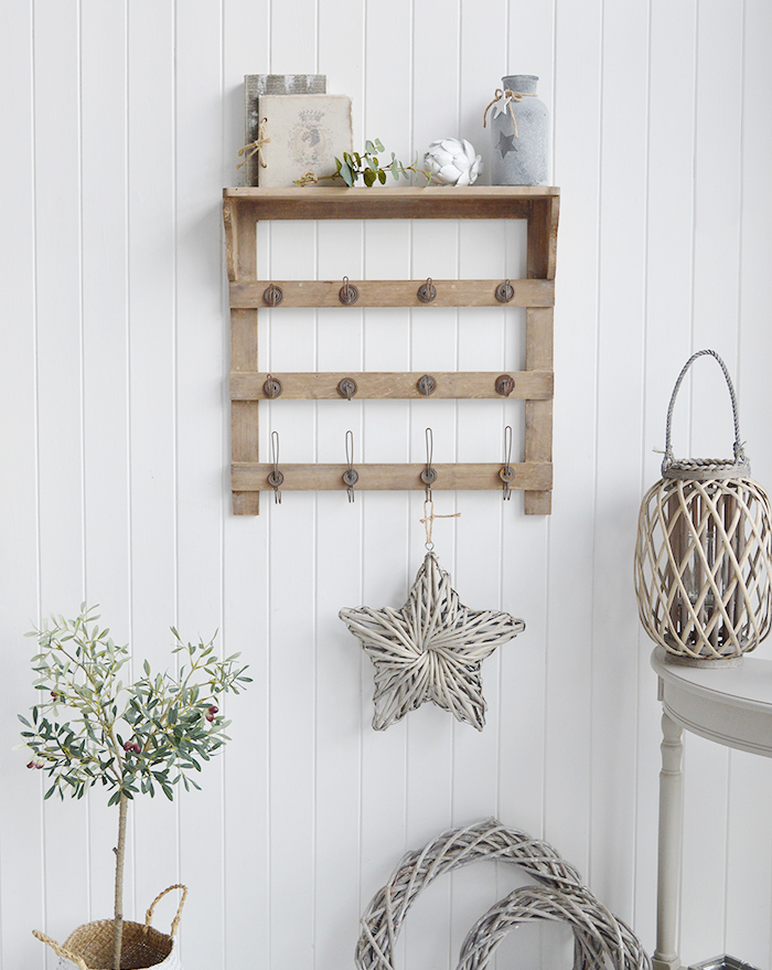 Pawtucket wooden wall shelf with hooks in greyed wood for the living room, bathroom, hallway or bedroom. Perfectly complements coastal, country and white furniture in New England Interiors and homes from The White Lighthouse. Coat storage hallway furniture or display