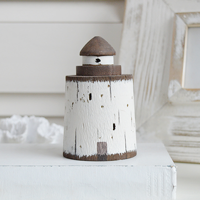 Little rustic driftwood wooden lighthouse for decorating a coastal room