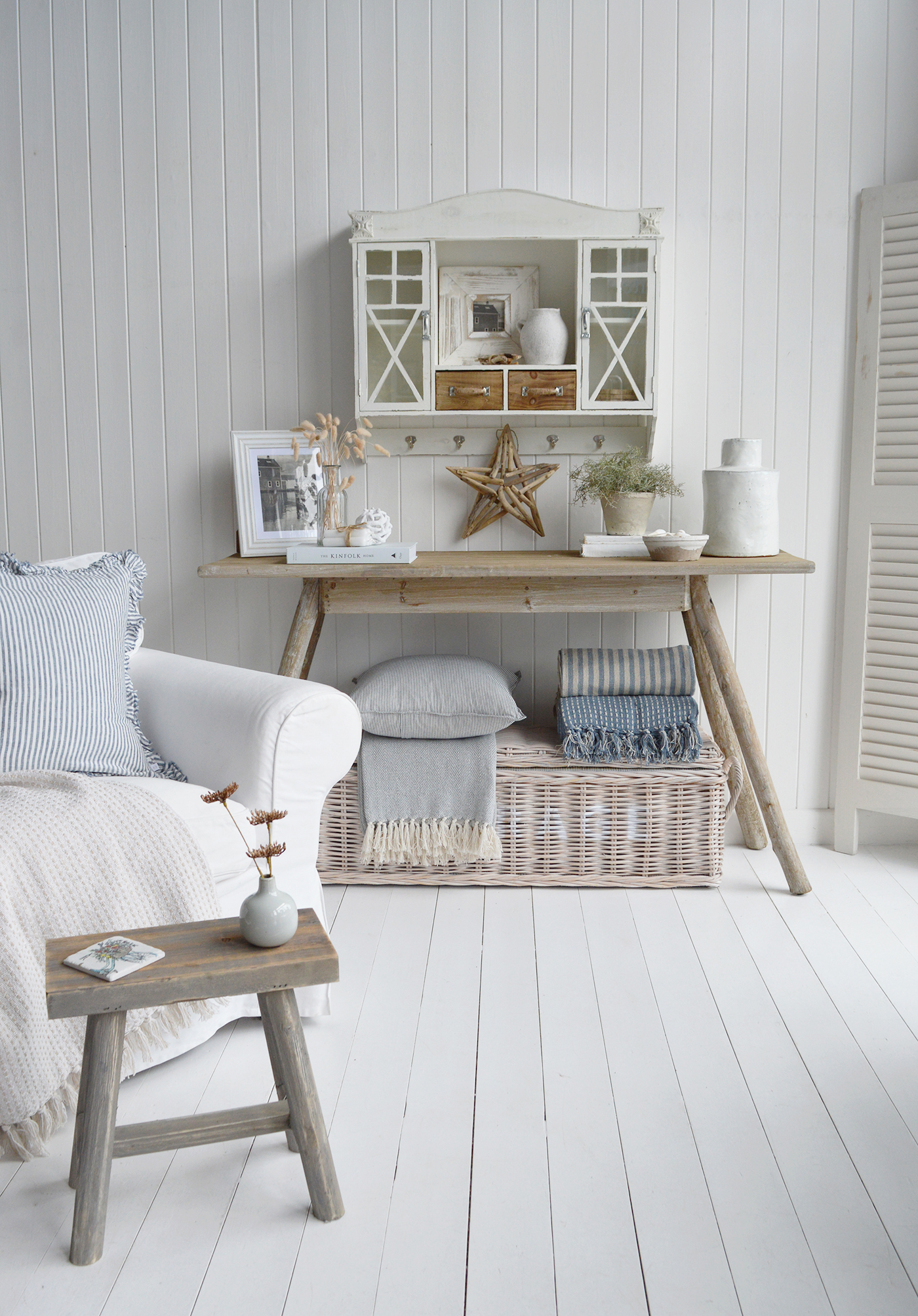 Modern country interiors with Hamptons style console table, wicker storage, and coastal chic accents in neutral tones.
