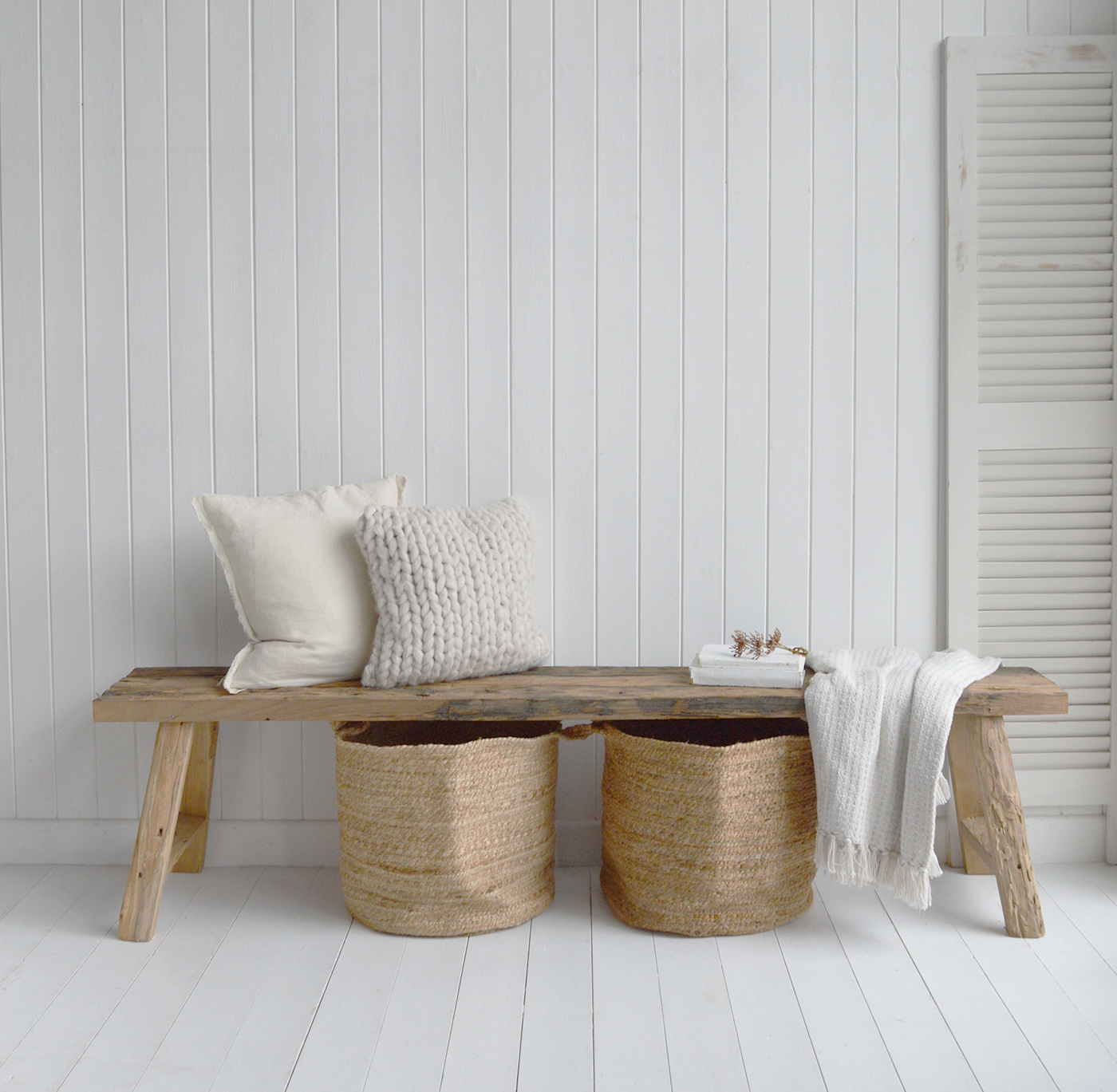 Pairing a rustic wooden bench with soft linen cushions creates a warm, welcoming look perfect for farmhouse kitchens.