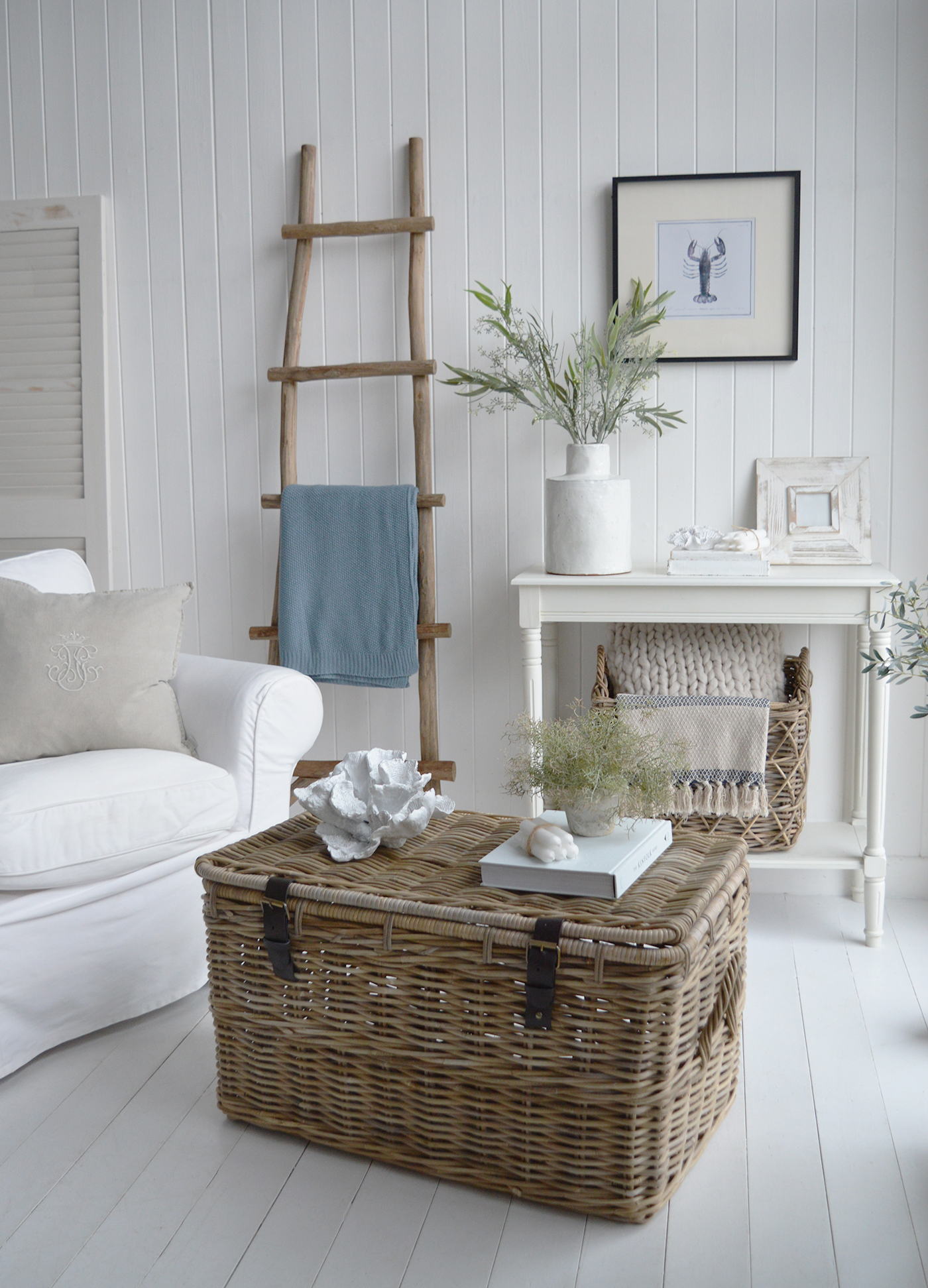 The Casco Bay trunk coffee table in a neutrally inspired living room alongside the driftwood ladder, for chic coastal style. Add a touch of rustic charm to your bedroom by using a driftwood blanket ladder to display cozy throws, linen blankets, or even string lights for a soft, ambient glow.

