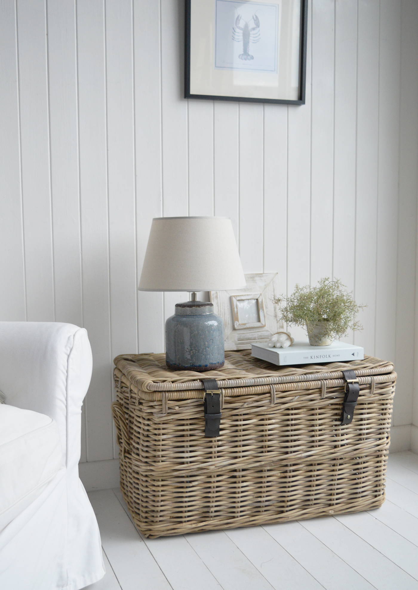 A close up photograph of the Casco Bay trunk as a side table with the Blue Compton lamp