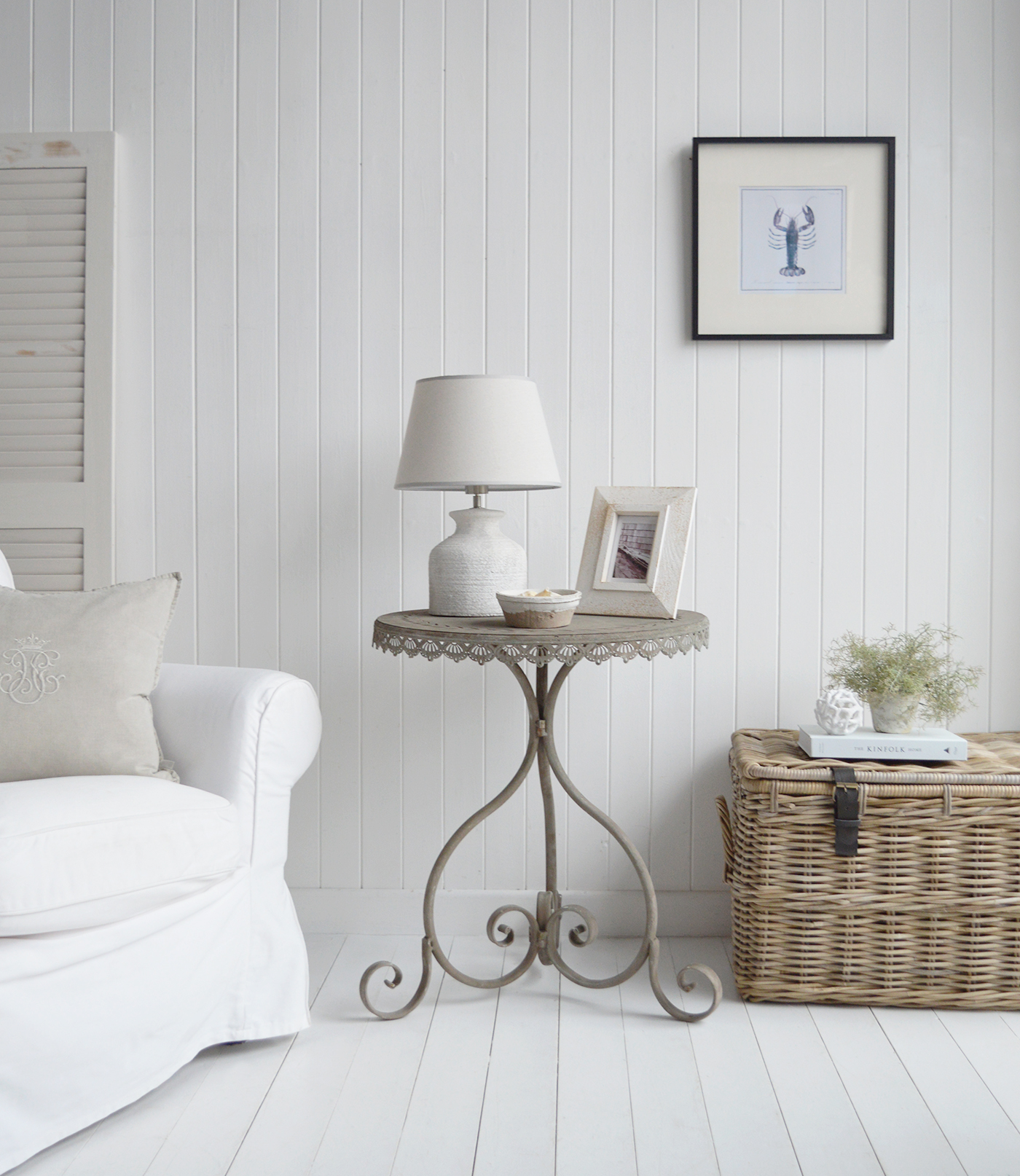 Featuring a weathered grey metal finish, this rustic table adds a touch of vintage character to both coastal and farmhouse-style living room interiors.