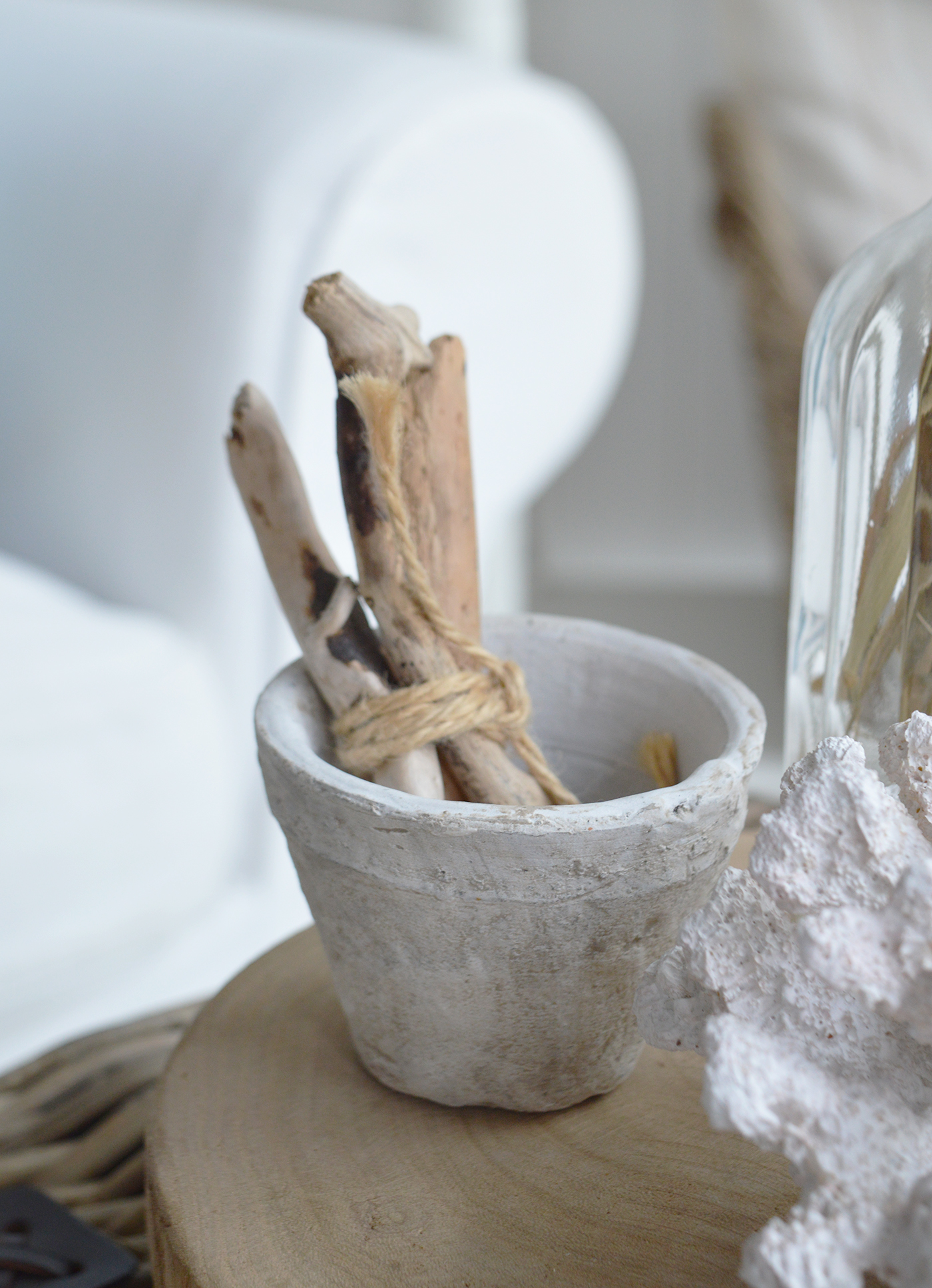 Decorative coral, driftwood and dried grasses add subtle seaside character without overwhelming the room.