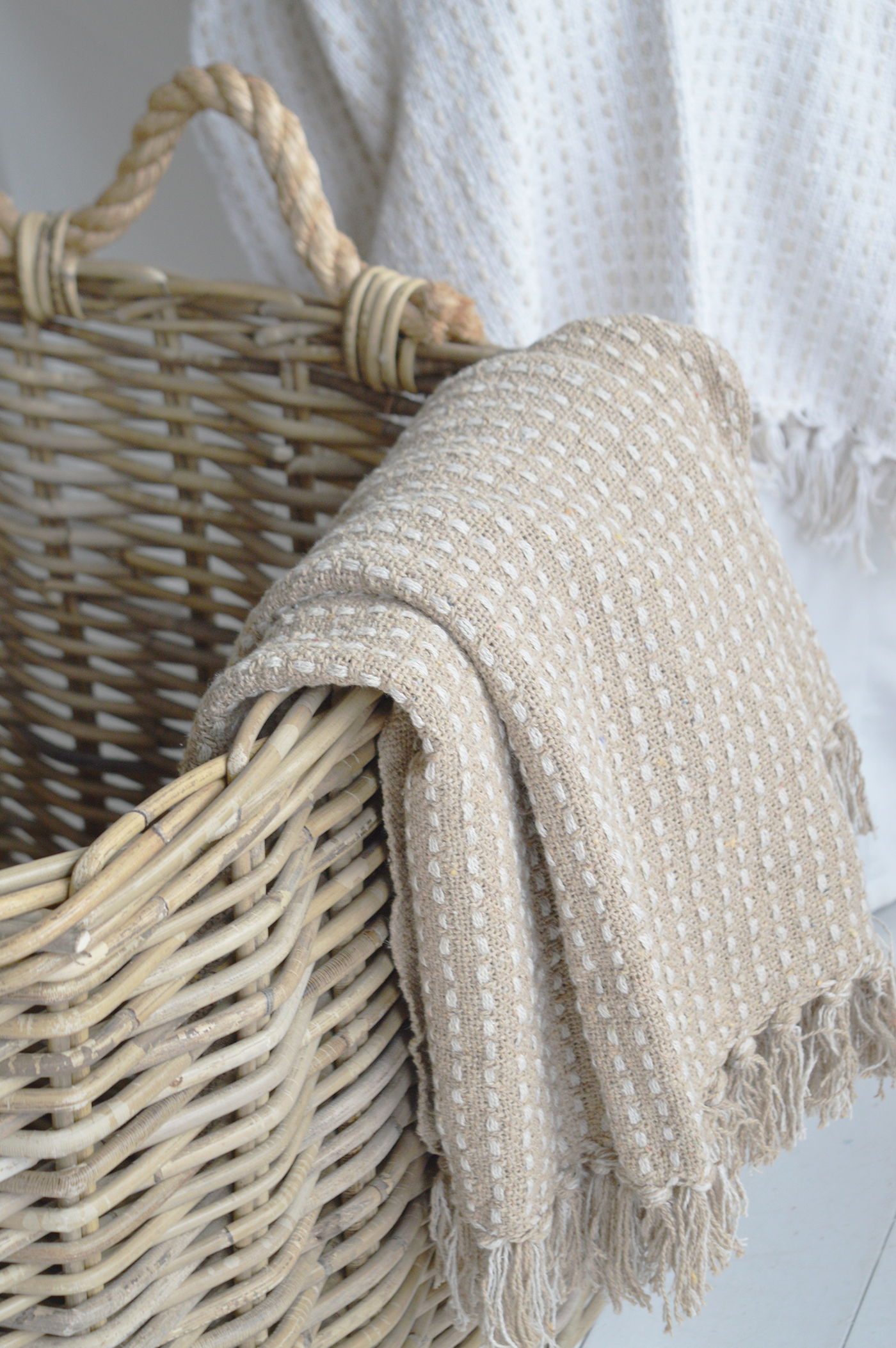 White panelled walls and natural woven accessories capture the relaxed elegance of Hamptons interiors.
