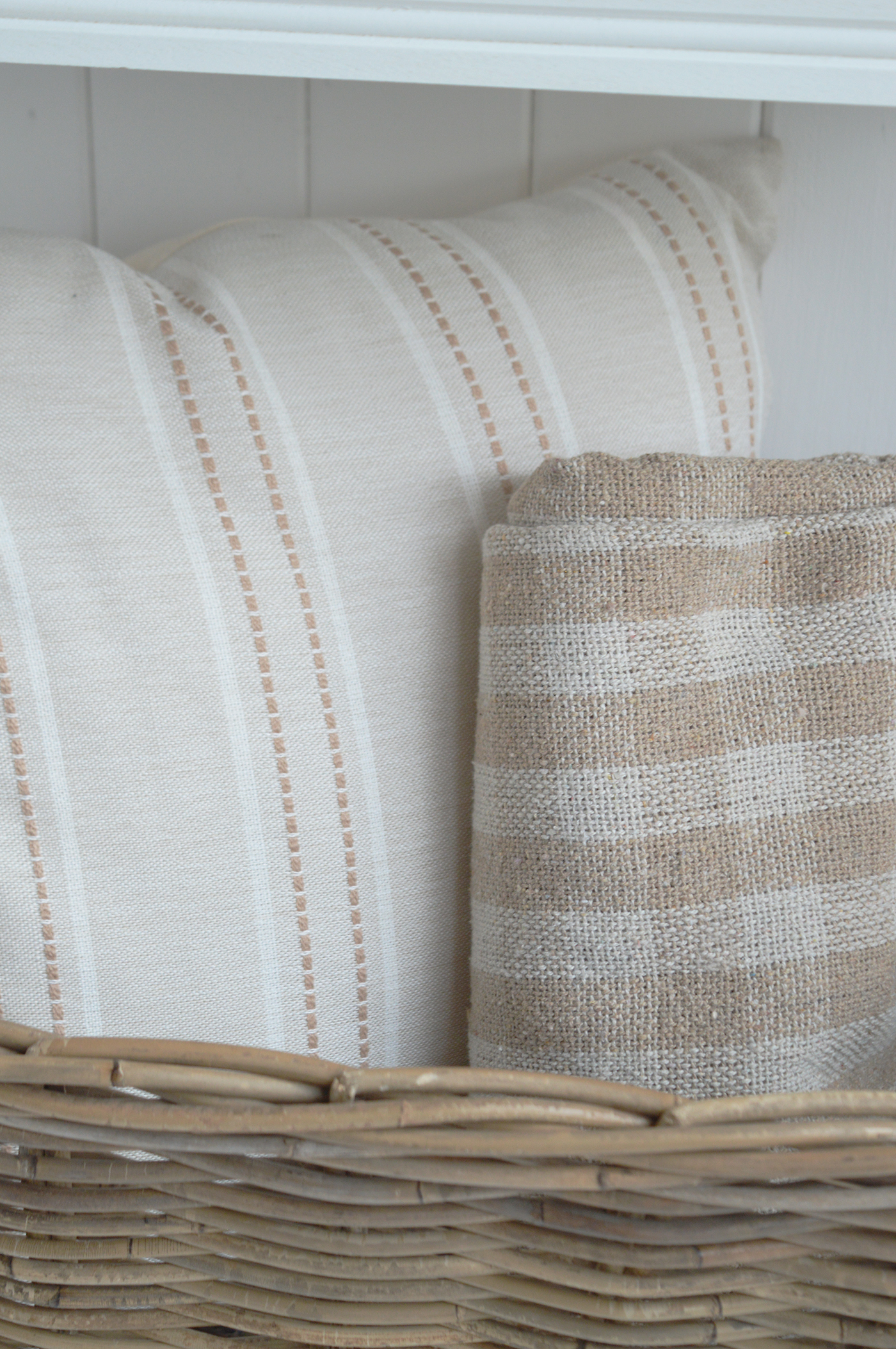 Natural rattan furniture adds warmth and texture to a light New England-style living room.