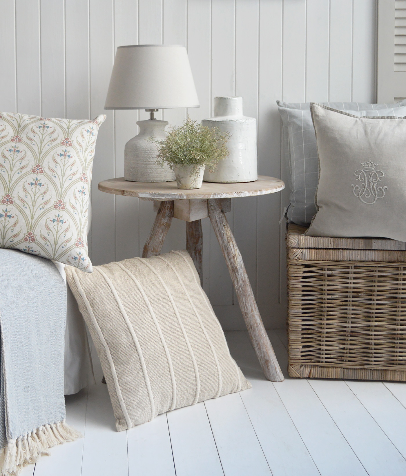 The driftwood coastal table with an array of neutral cushions