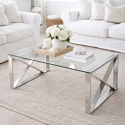 Glass coffee table with polished stainless steel X-frame base. A timeless centrepiece for Hamptons and neutral living room interiors