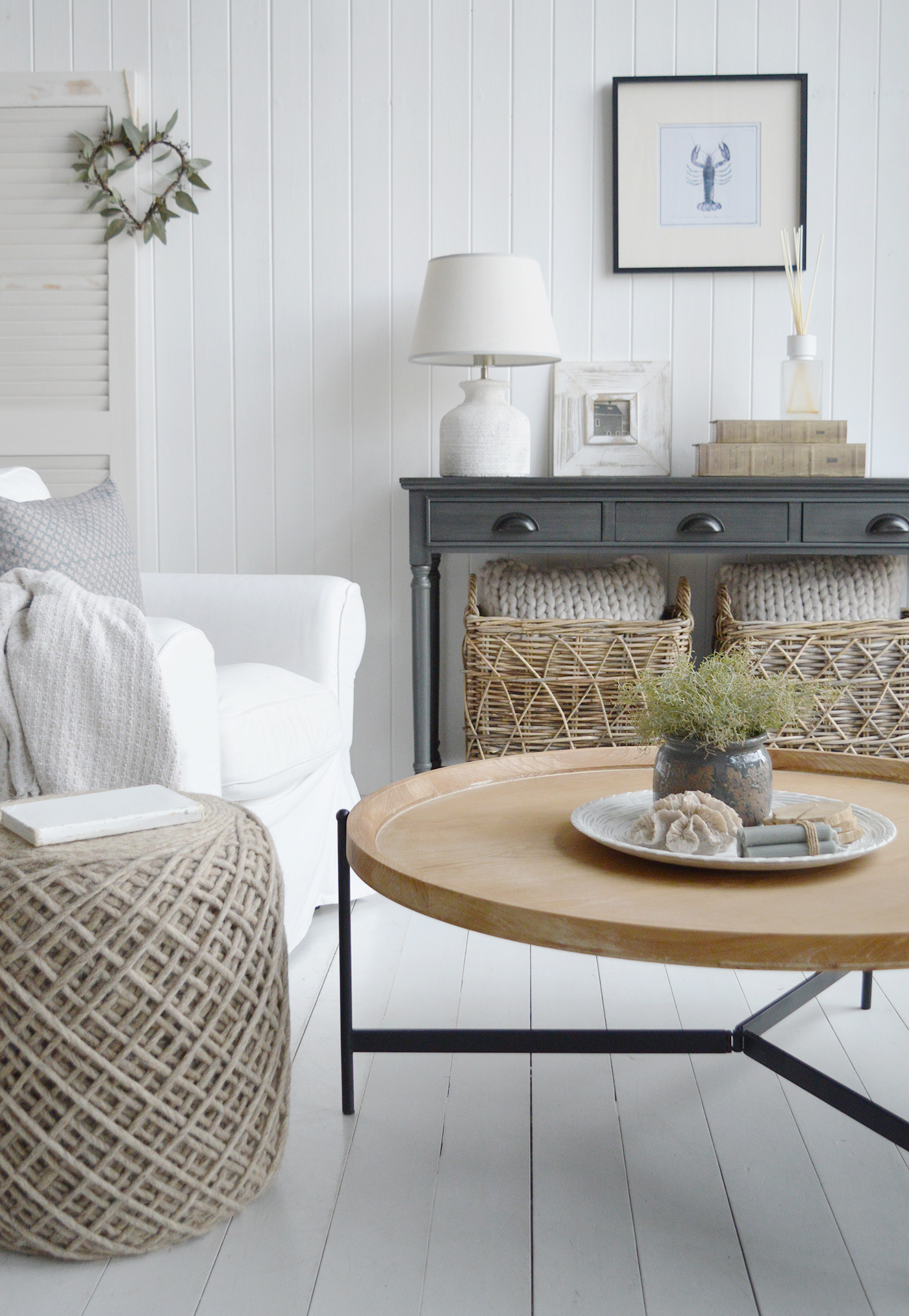 This coastal living space pairs the Greyhaven Console in Weathered Slate with the Salisbury Washed Wood Coffee Table, creating a perfect balance of depth and natural warmth