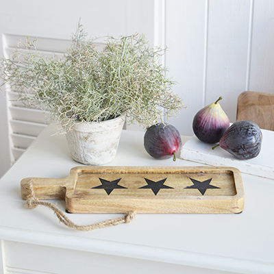 A wooden paddle board tray with stars, perfect for serving in A New England styled home coastal or farmhouse interior