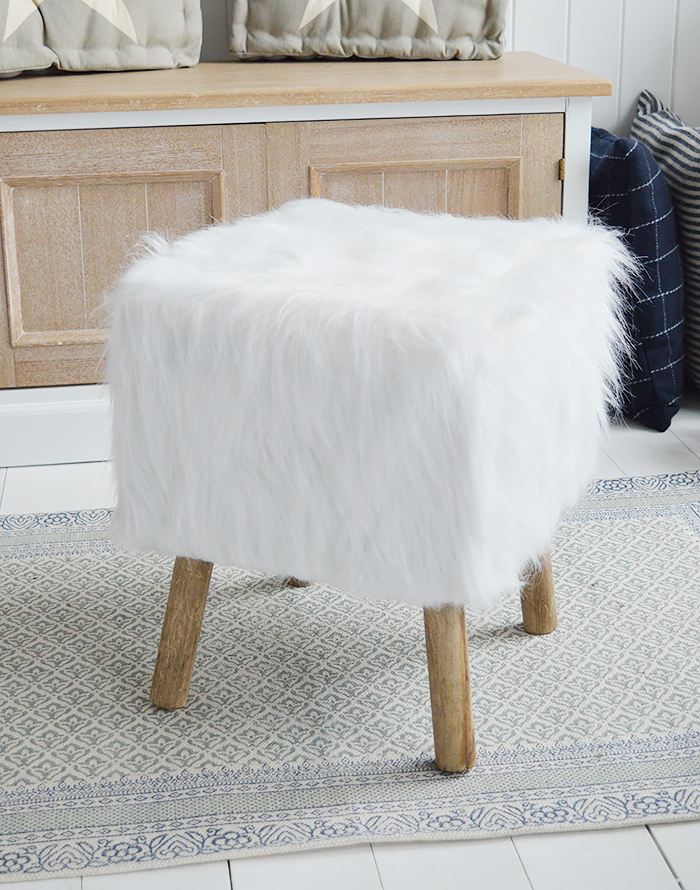 The Woodstock square white faux sheepskin fur stool with four contrasting legs in a rich coloured wood. Inspired by the laid back style of New England living in the country, by the coast and in the city, our beautiful Woodstock white foot stool adds warmth and texture to a room while offering extra seating and a comfortable place to rest your feet.