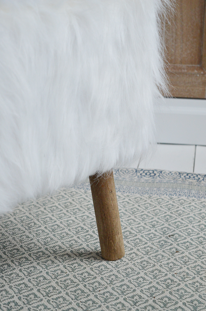 The Woodstock square white faux sheepskin fur stool with four contrasting legs in a rich coloured wood. Inspired by the laid back style of New England living in the country, by the coast and in the city, our beautiful Woodstock white foot stool adds warmth and texture to a room while offering extra seating and a comfortable place to rest your feet.