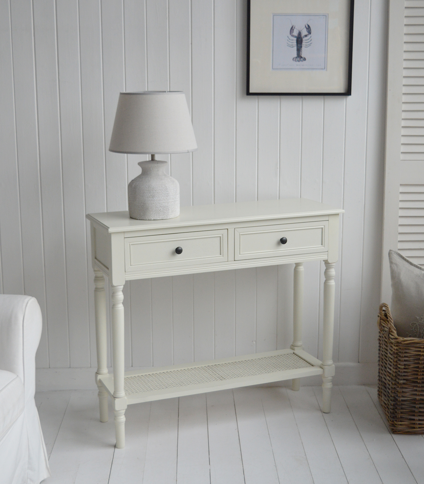 The Sullivan cream console tahble with drawers and rattan shelf