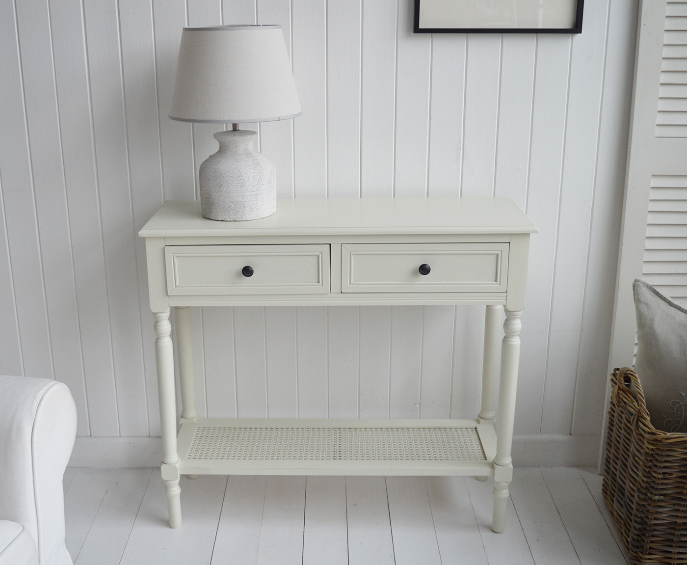 The Sullivan cream console tahble with drawers and rattan shelf