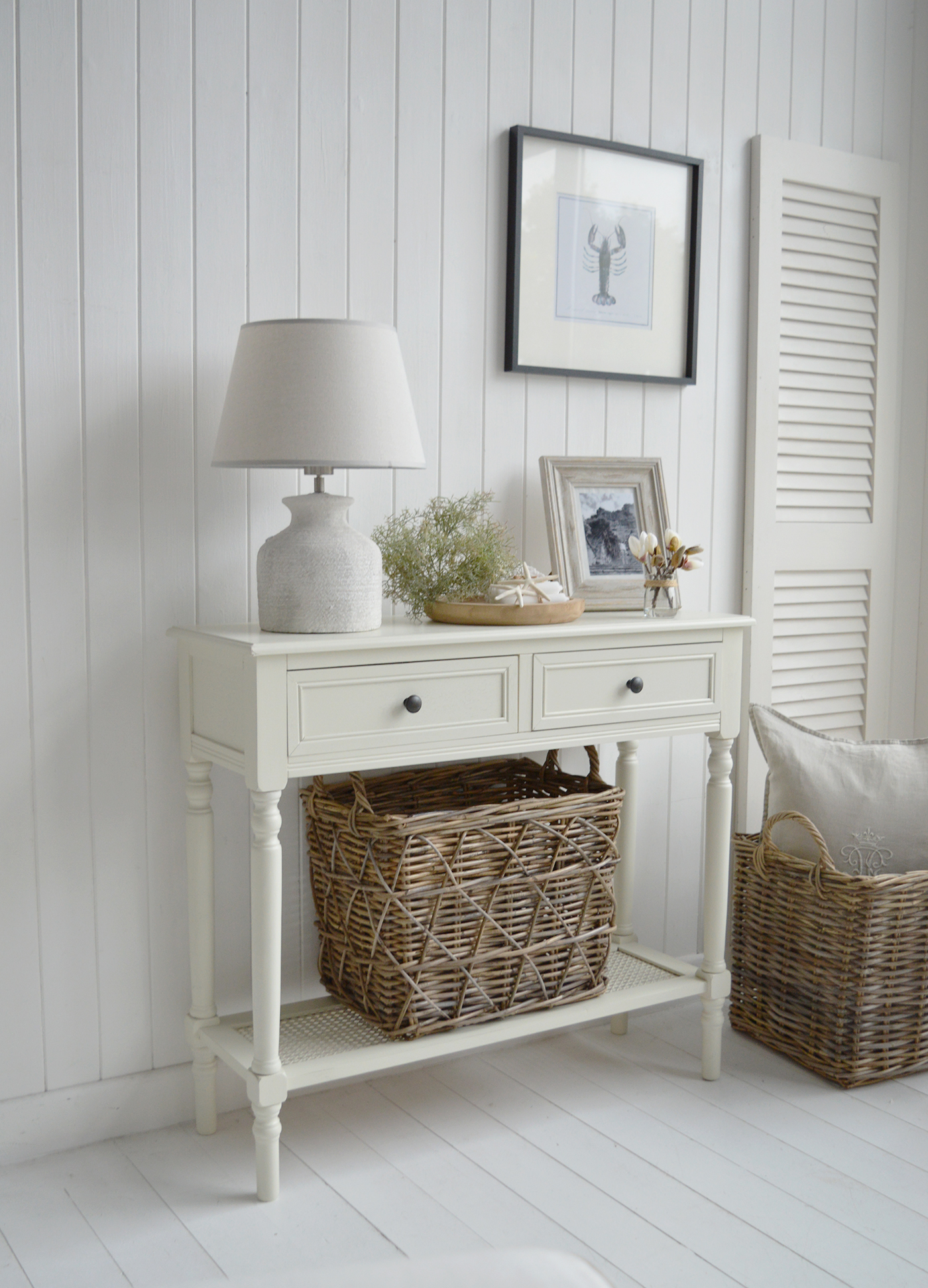 The Sullivan coastal cream console table with rattan shelf and two drawers